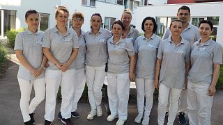 Juliana and her colleagues outside the hospital where she works