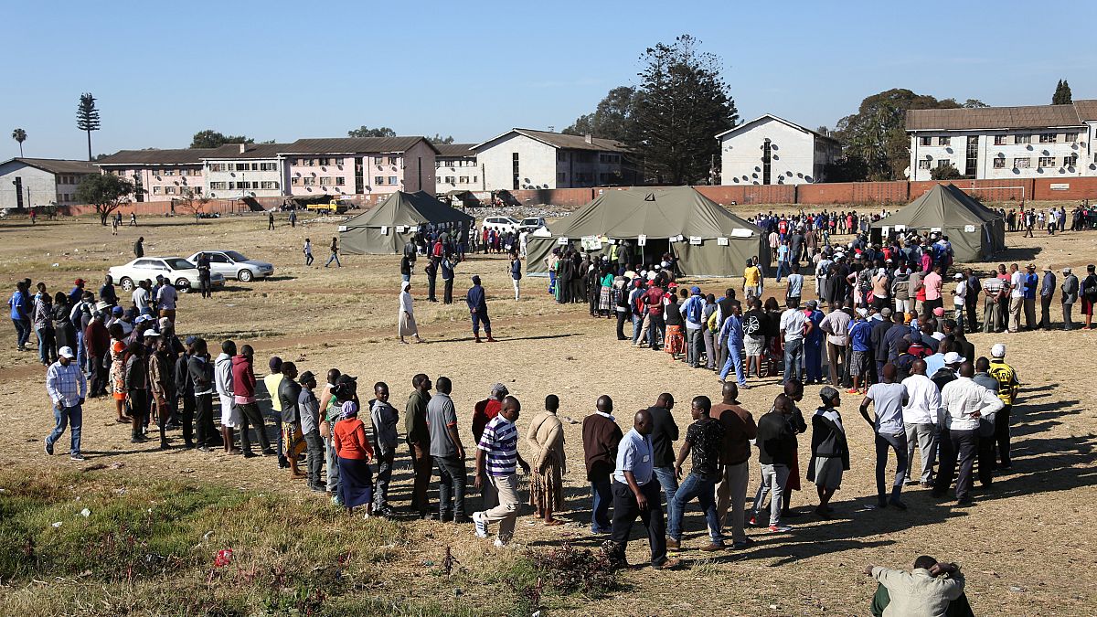 Voters queue to cast ballots in Harare, 30 July 2018