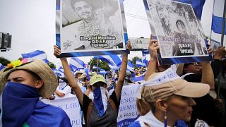Tüntetők a zavargások során megölt diákok képeivel a kezükben Nicaraguában
