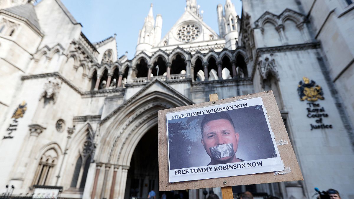 A poster supporting Tommy Robinson outside the High Court in London