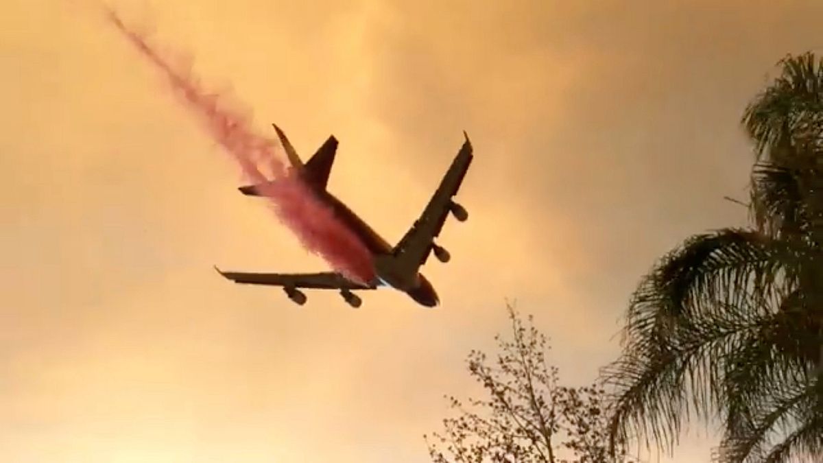Um avião despeja retardante de fogo no combate ao "Holy Fire"