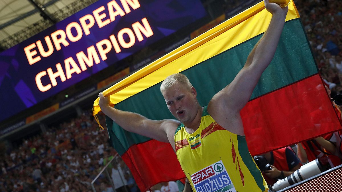 Andrius Gudžius of Lithuania celebrates winning a gold medal