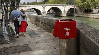 A couple walks near eco-friendly urinal on the Ile Saint-Louis