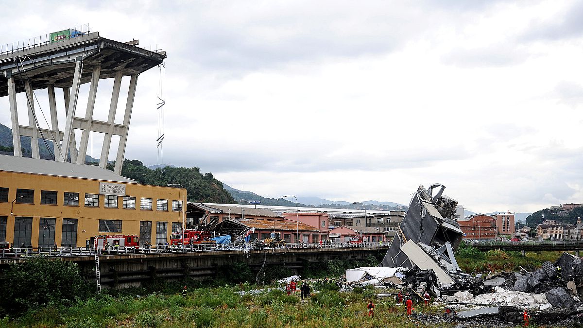 Rescue workers are seen at the collapsed Morandi Bridge near Genoa, Italy