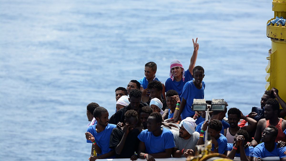 Migrants rest on board migrant rescue ship Aquarius
