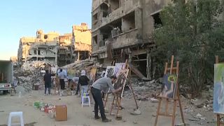 Refugee artists return to Yarmouk camp in Syria to paint dreams