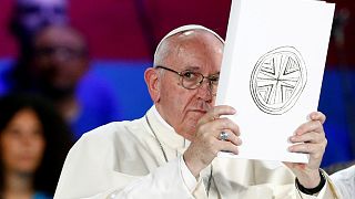 File photo: Pope Francis holds the Book of the Gospels