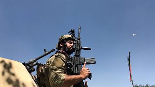 Member of the Afghan security forces keeps watch at the site of th attack