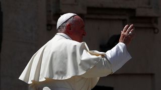 Pope Francis waves in St. Peter's square at the Vatican