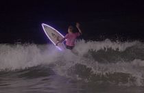 Watch: Surfers catch waves under moonlight