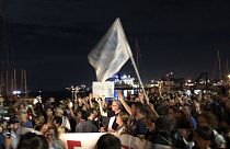 Protestors show up with arancini to show support for stranded migrants 