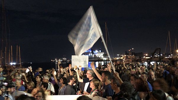 Protestors show up with arancini to show support for stranded migrants Protestors show up with arancini to show support for stranded migrants