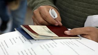 A man holding a passport