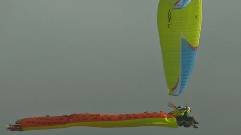 Watch: Costume-clad paragliders descend over the Andes