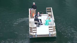 Watch: Orchestra players perform on water