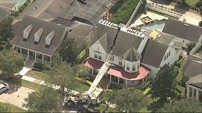 Crane falls onto Orlando home, slicing roof