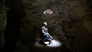 A man takes shelter in an underground cave in Idlib, Syria