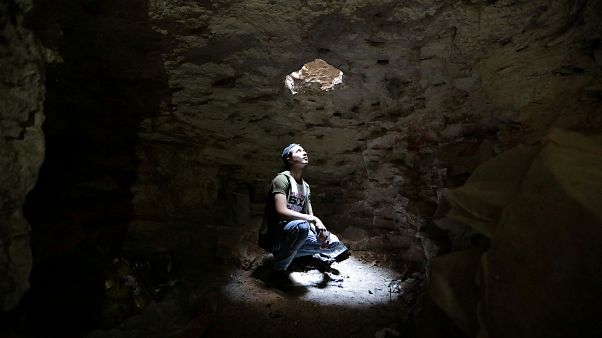 A man takes shelter in an underground cave in Idlib, Syria A man takes shelter in an underground cave in Idlib, Syria