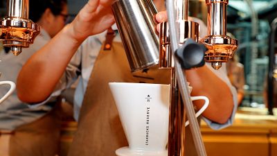 An employee prepares coffee at the new Starbucks Reserve location in Milan
