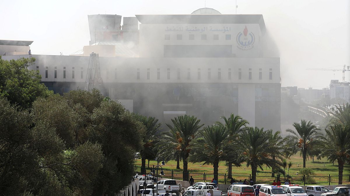 Smoke rises form the headquarters of Libyan state oil firm NOC