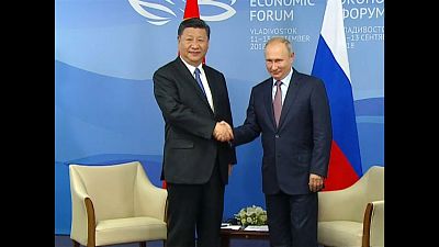 Putin and Xi flip pancakes together