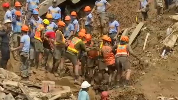 rescue workers dig for bodies after a landslide in northern Philippines rescue workers dig for bodies after a landslide in northern Philippines