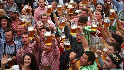 Visitors cheer during the opening day of the 185th Oktoberfest in Munich