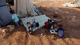 Newly displaced Syrian children play after their arrival to a camp in Idlib