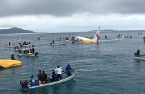 People are evacuated from an Air Niugini plane crashed in Micronesia