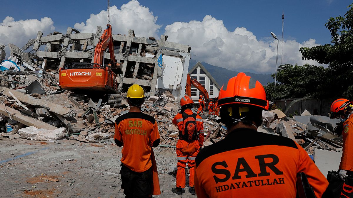 Rescuers on Sulawesi Island, Indonesia work in the rubble of a hotel