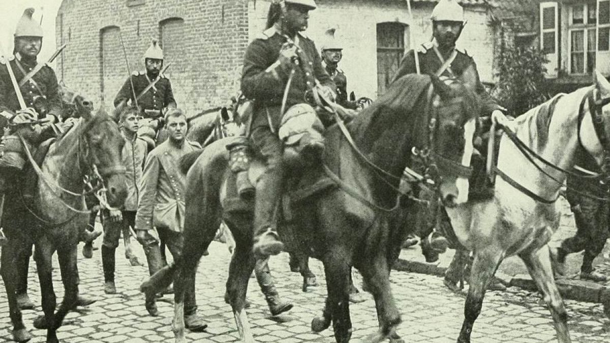 French cavalry marching German prisoners through the town of Aniche.