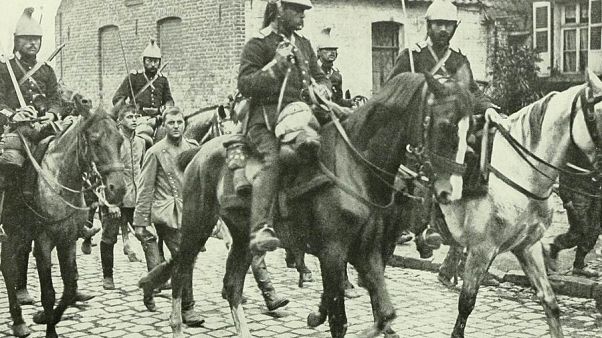 French cavalry marching German prisoners through the town of Aniche. French cavalry marching German prisoners through the town of Aniche.