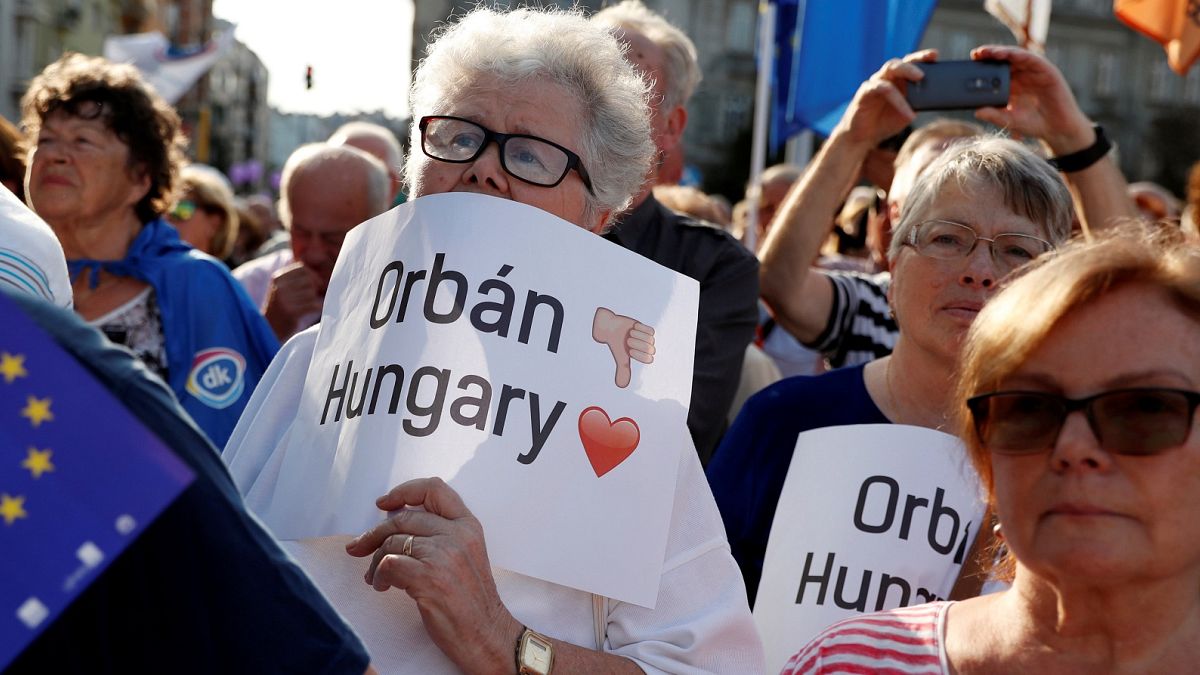 People attend a demonstration against Hungary's Prime Minister Viktor Orban