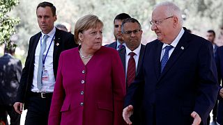 Angela Merkel stands next to Israeli President Reuven Rivlin 