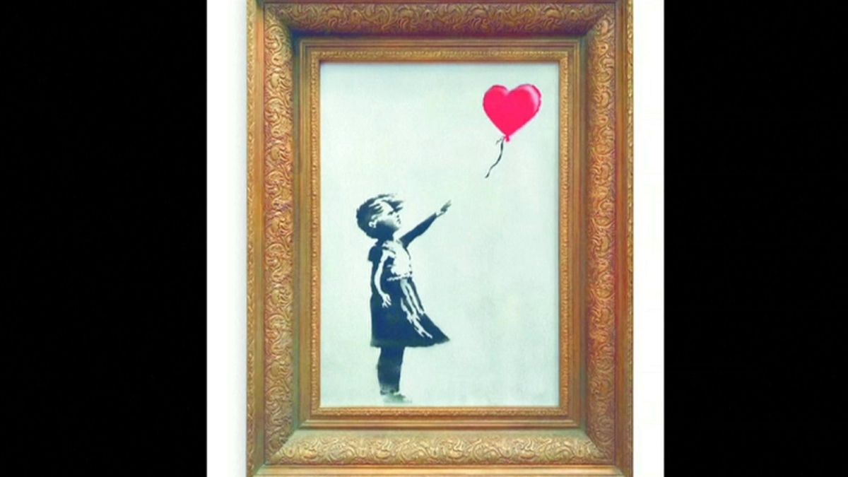 Banksy painting 'self-destructs' in artist's prank at auction