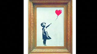 Banksy painting 'self-destructs' in artist's prank at auction