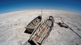 Boats on the dried lake Poopo affected by climate change, in Bolivia.