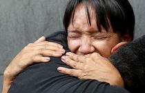Mourners react outside National Intelligence Service building in Caracas