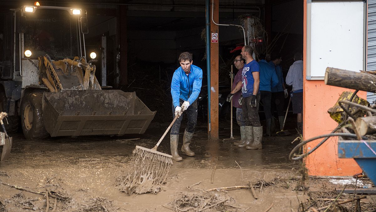 Rafael Nadal helps with the cleanup after floods in Mallorca