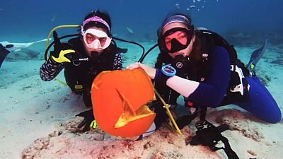 Scuba divers take a Halloween tradition underwater