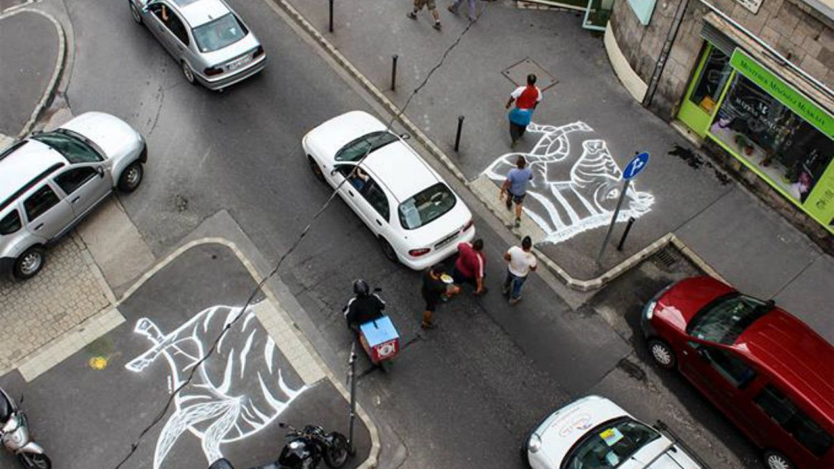 Activists paint zebra's head and tail near road in bid to get crossing