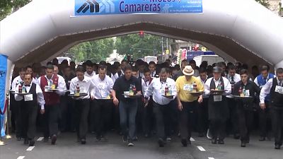 Argentine waiters race to the finish line during annual competition