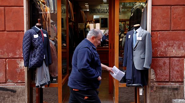 A man walks past a clothing shop in Rome, Italy October 22, 2018. A man walks past a clothing shop in Rome, Italy October 22, 2018.