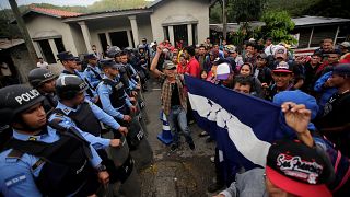 Migrants are confronted by police at the Honduras-Guatemala border