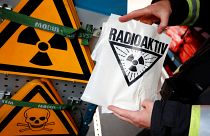 A firefighter displays a radioactive sign during an emergency drill