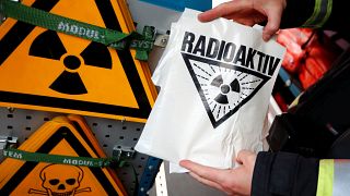 A firefighter displays a radioactive sign during an emergency drill 