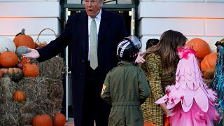 Donald and Melania Trump hand out Halloween sweets to children at White House