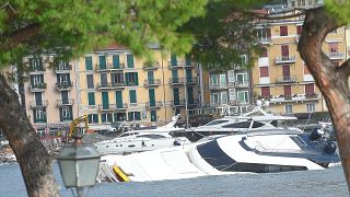 Semi-submerged yachts are seen in the harbour after windstorm and the stron