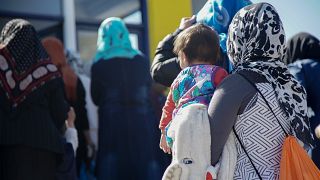 Refugee/migrant children & women enter the UNICEF-backed center in Moria