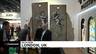 Banksy creates replica separation wall for London travel fair